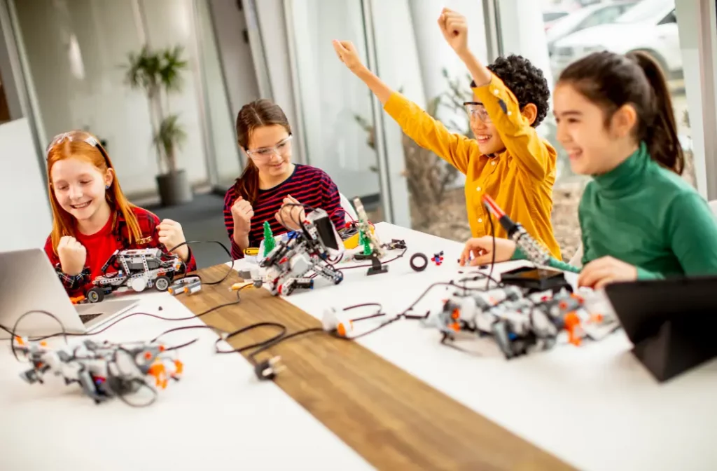 Extracurriculars for children from 6 to 12 years old - Happy kids in robotics class