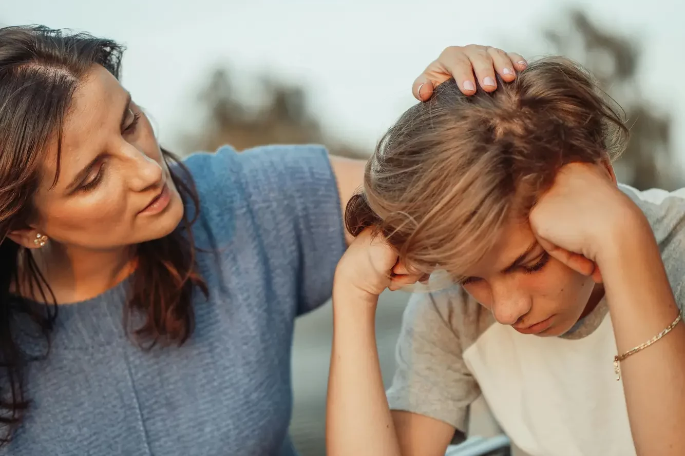 Back to school anxiety.
Woman supporting worried girl. 