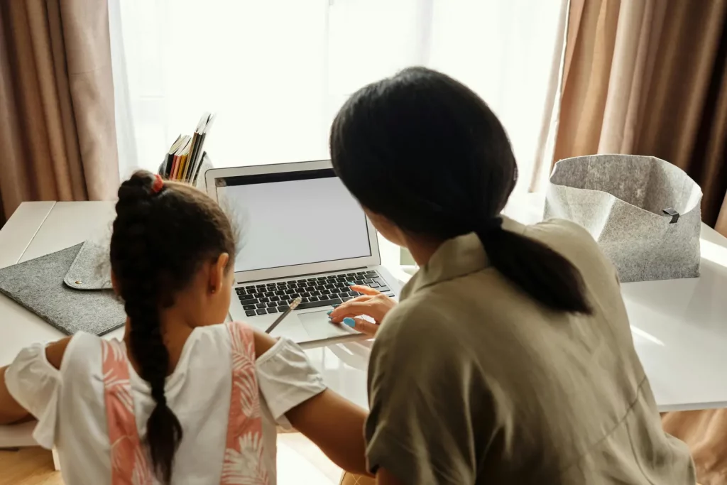 Woman and child studying together.